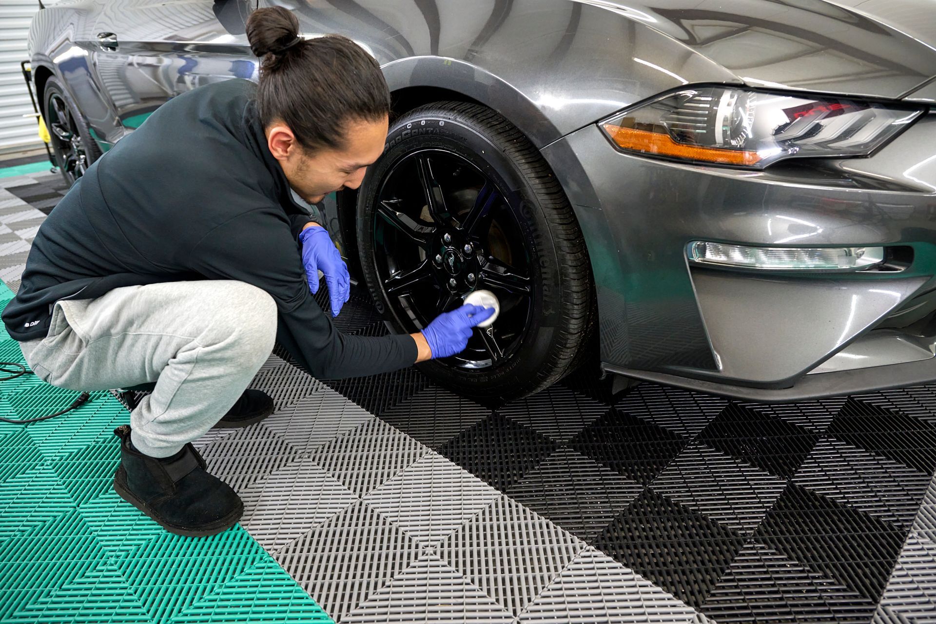 Technician applying ceramic coating to vehicle wheel, GT Tinting Hampton VA