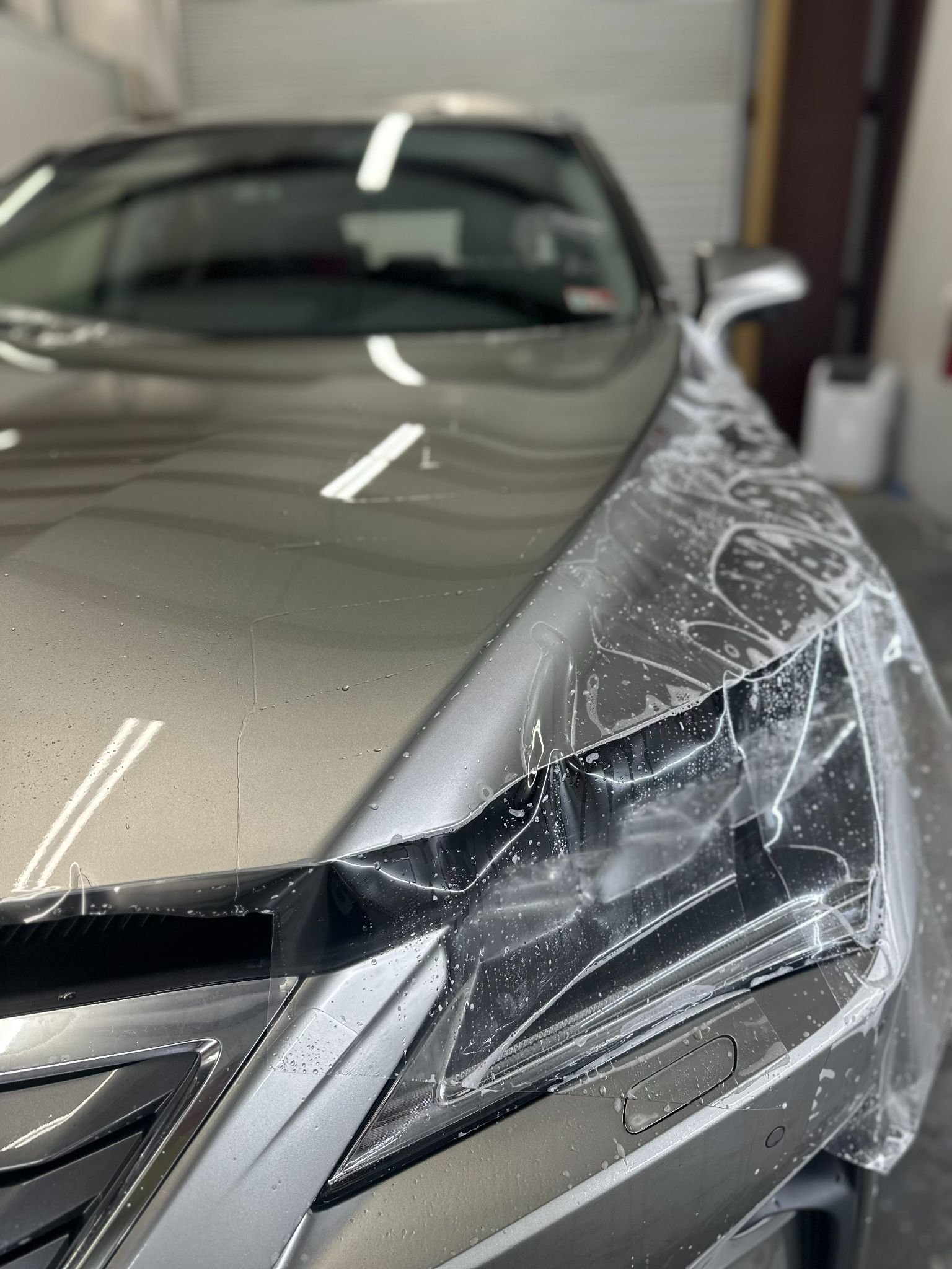 Close-up of a car with Paint Protection Film applied, highlighting a glossy, scratch-free surface.