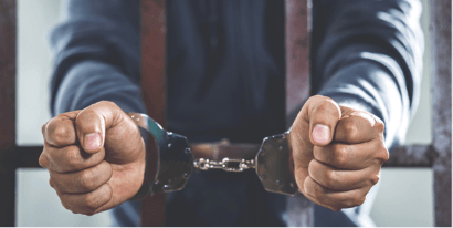 A man's hands in handcuffs.