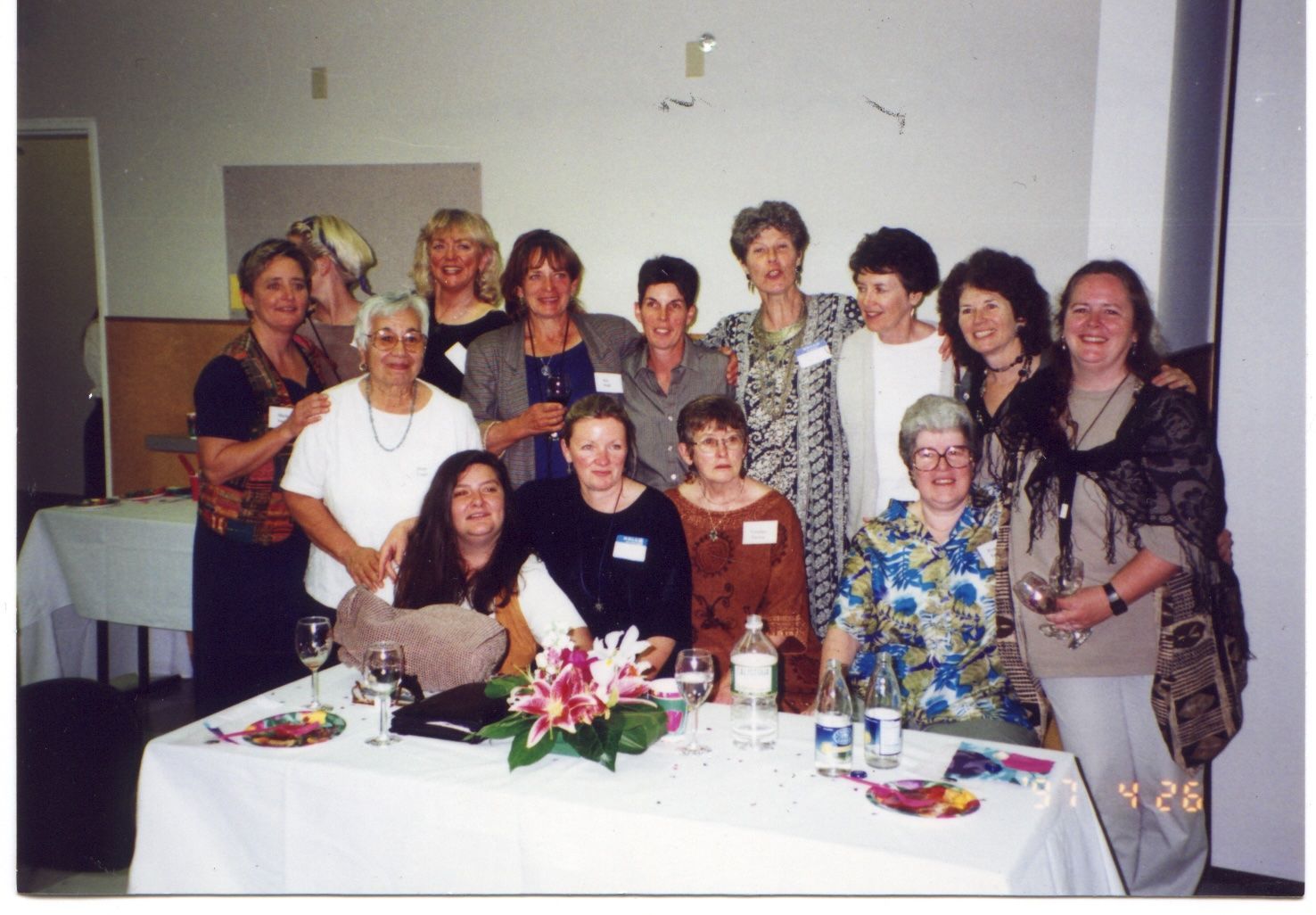 The support committee of the
Women’s Re-Entry Program, several women seated and standing around a decorated table. 