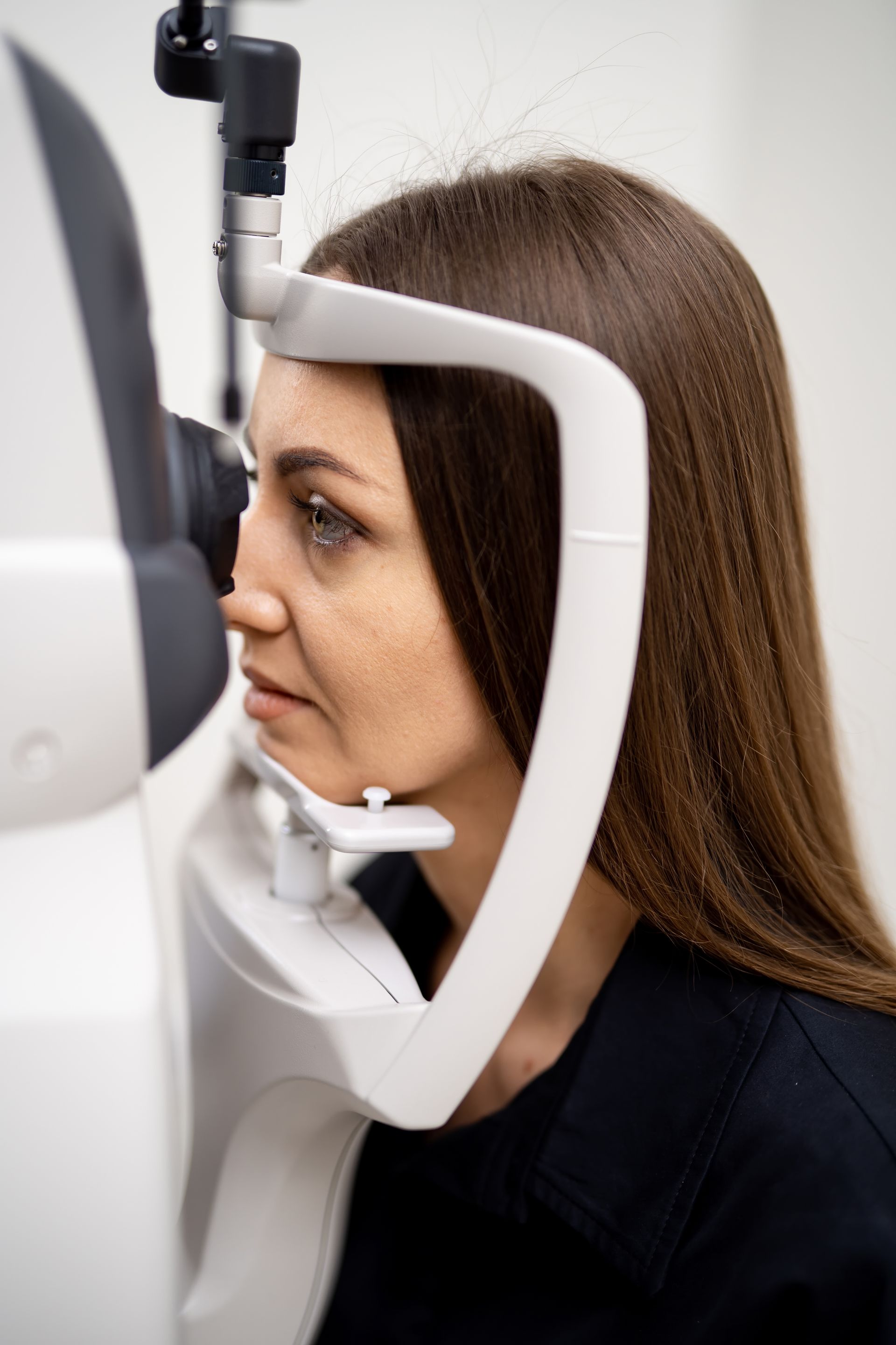 A woman is getting her eyes checked by an ophthalmologist.