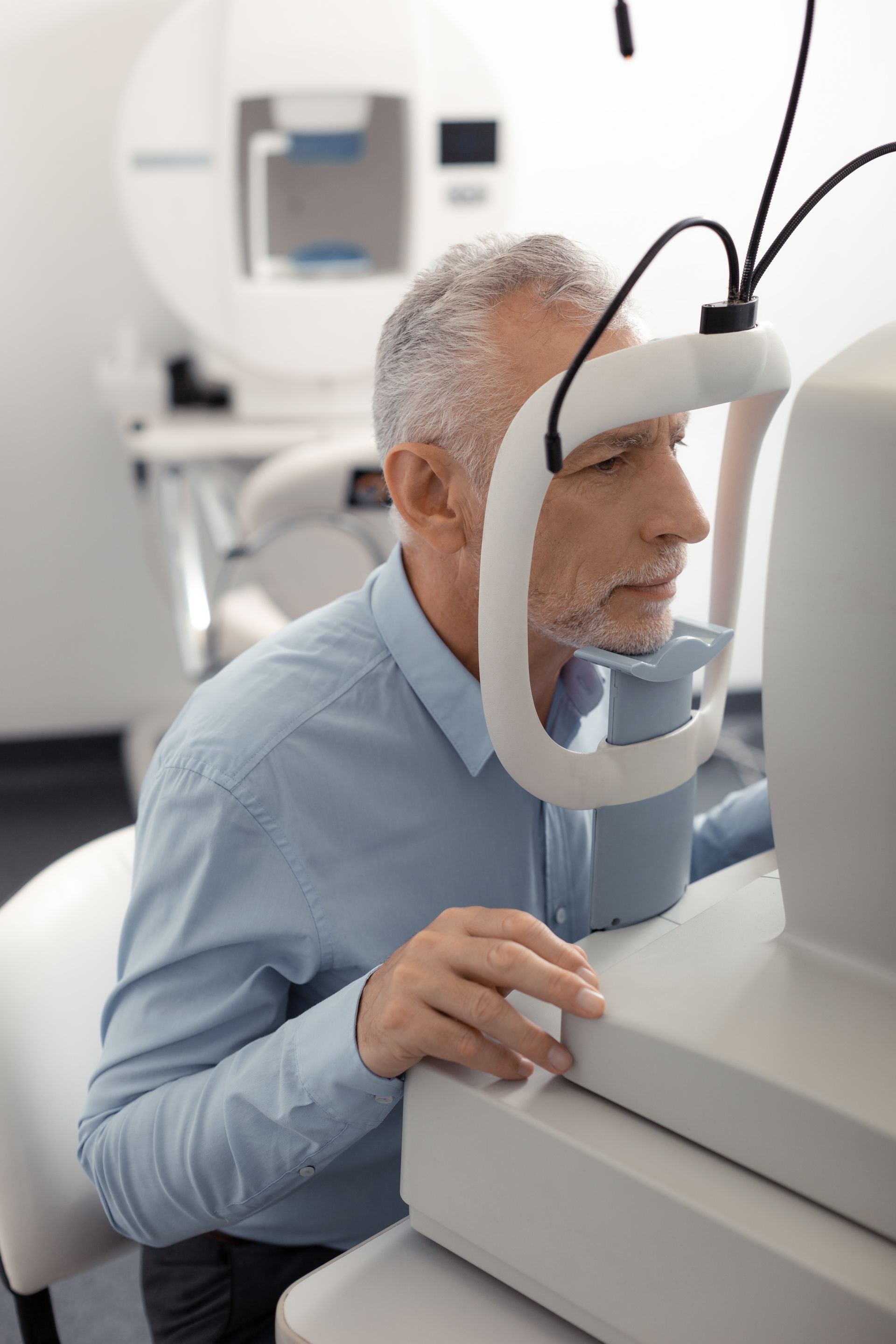 Person using a retinal scanner in a medical exam room