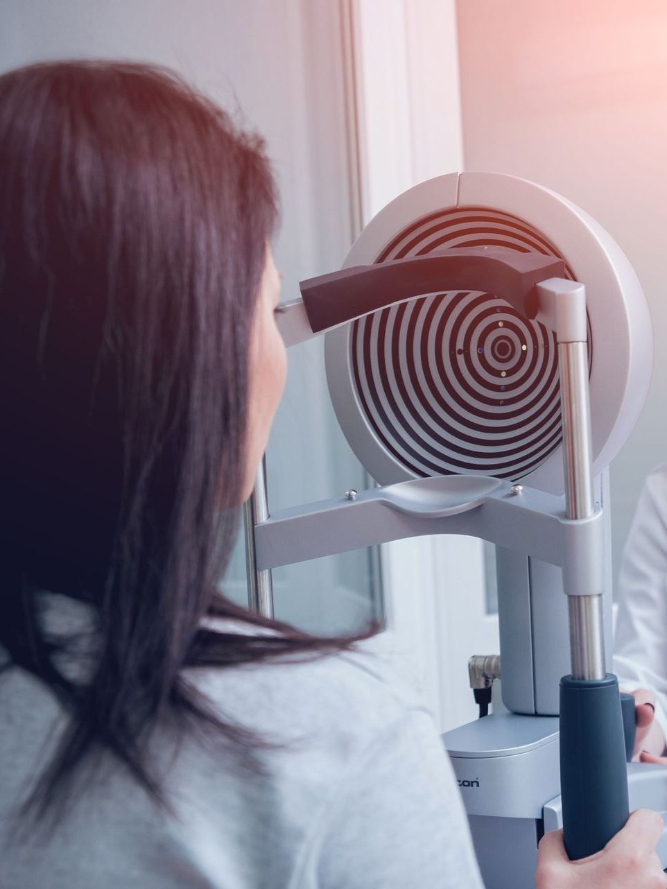 A woman is getting her eyes checked by an ophthalmologist.