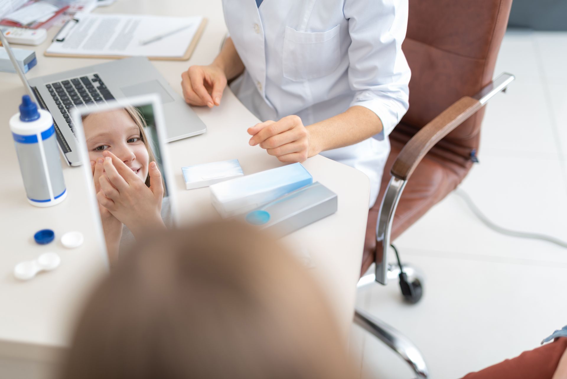 Person showing a facial treatment on a tablet during a cosmetic consultation at a desk