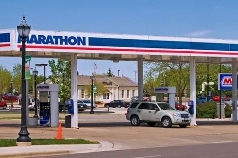 Marathon gas station with canopy, parked SUV, and streetlamp on a sunny day