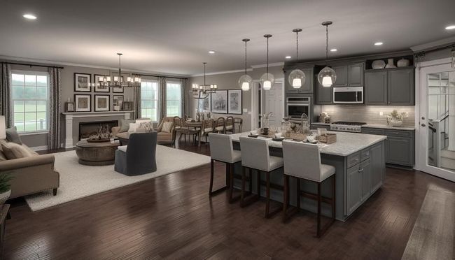 Modern open-concept kitchen and living room with gray island, pendant lights, and dark wood floors