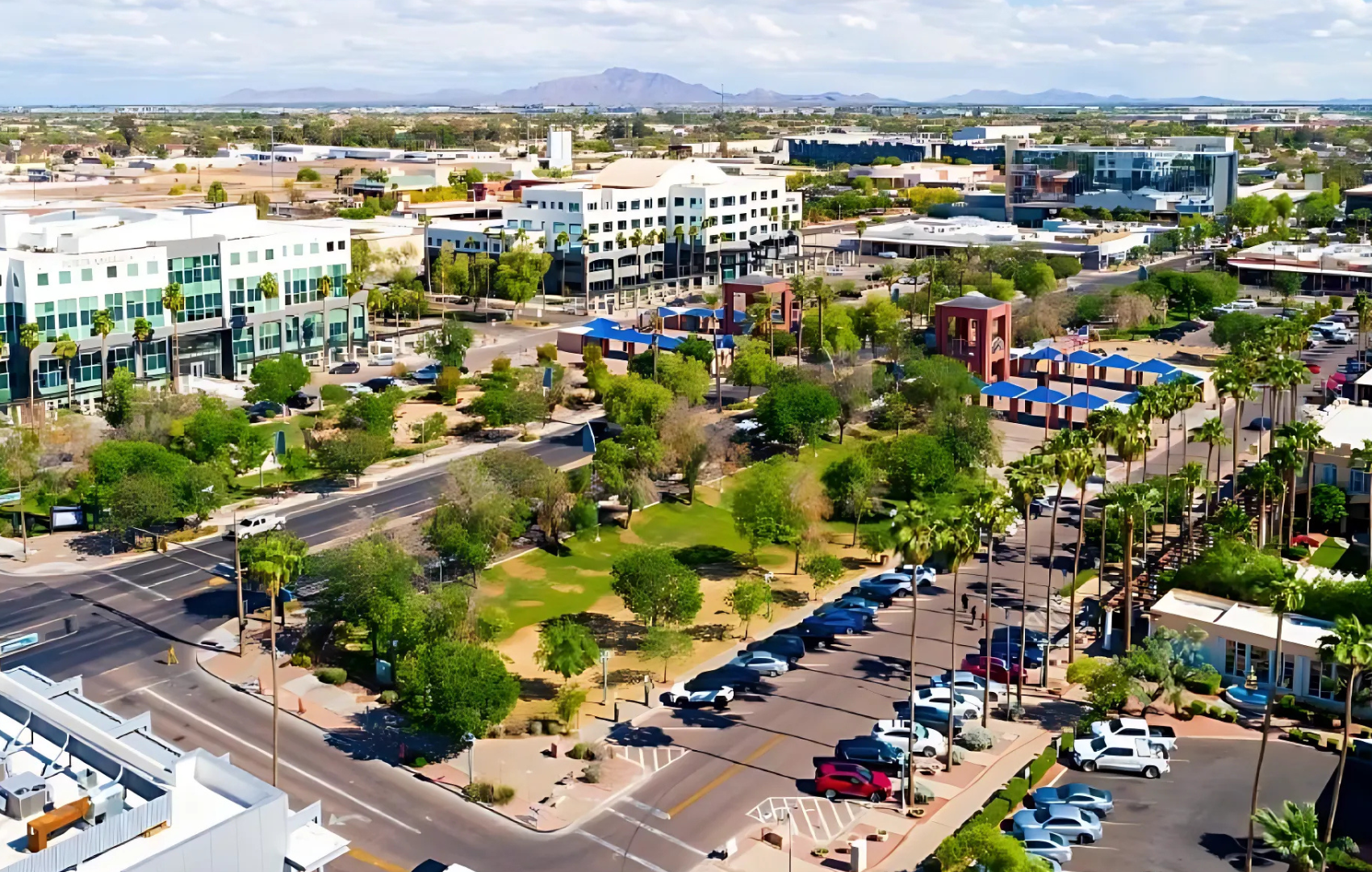 An aerial view of a city with lots of buildings and trees