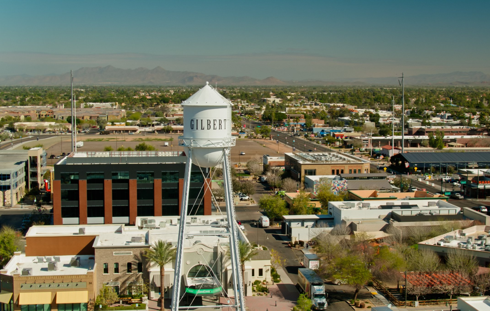 An aerial view of a city with a water tower in the foreground