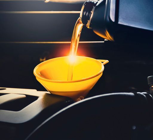 Mechanic Man Pouring Lubricant Oil To Car Engine In The Repair Garage — Bearfast Bearquip In Moree NSW