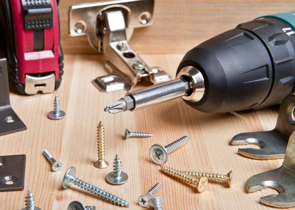 Screwdriver With Screws On Wooden Background — Bearfast Bearquip In Tamworth NSW