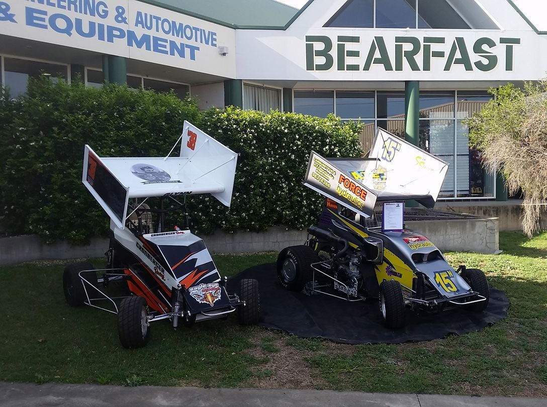 The Shop front of Bearfast with two small race cars 