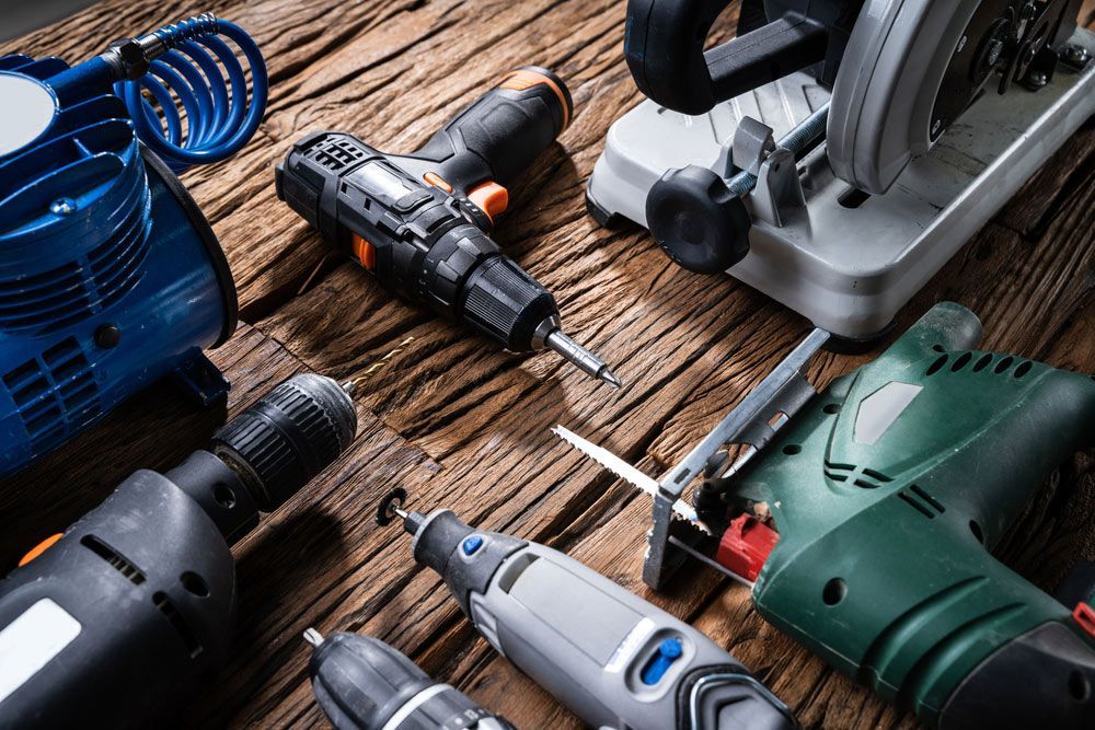 Various Power Tools Laying On Wooden Desk — Bearfast Bearquip In Taminda NSW