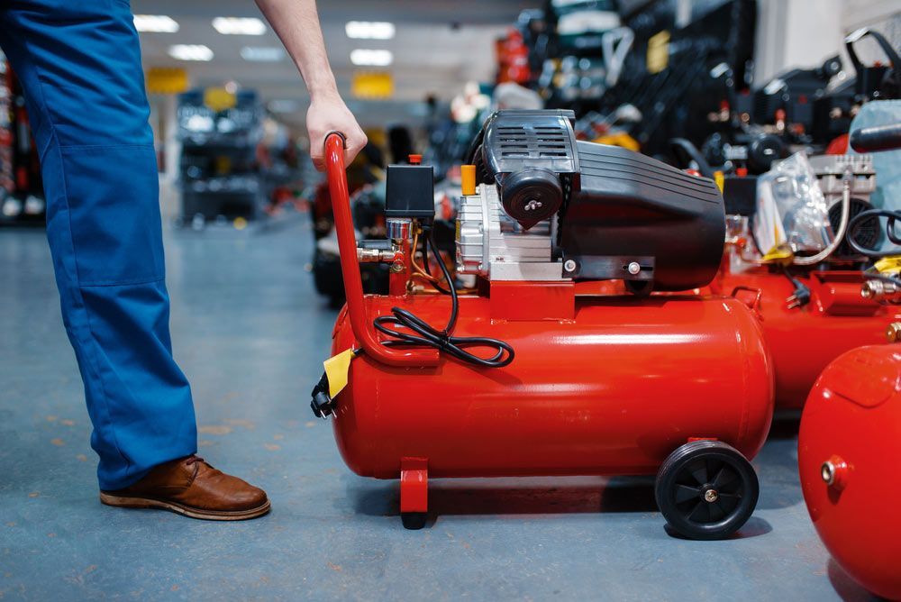 Worker Choosing Pneumatic Compressor In Tool Store — Bearfast Bearquip In Tamworth NSW