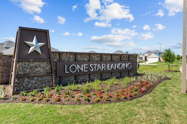 Sign for Lone Star Landing neighborhood with Texas star, brown and stone.