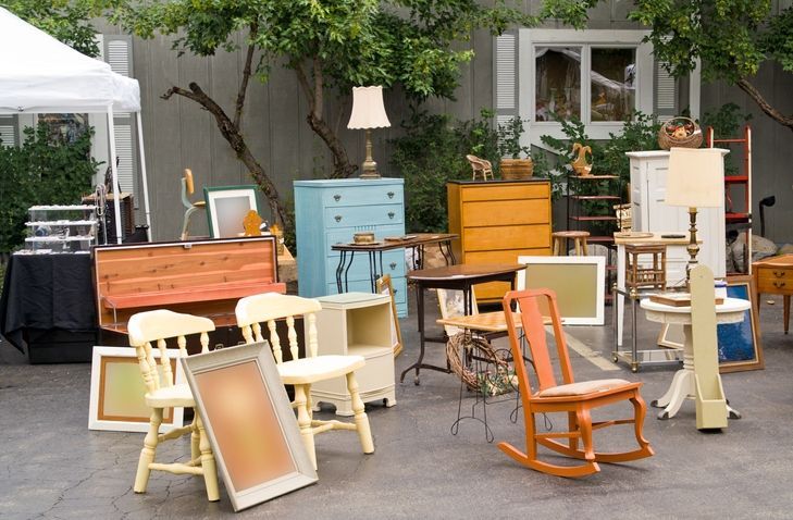 A bunch of antique furniture including rocking chairs and dressers