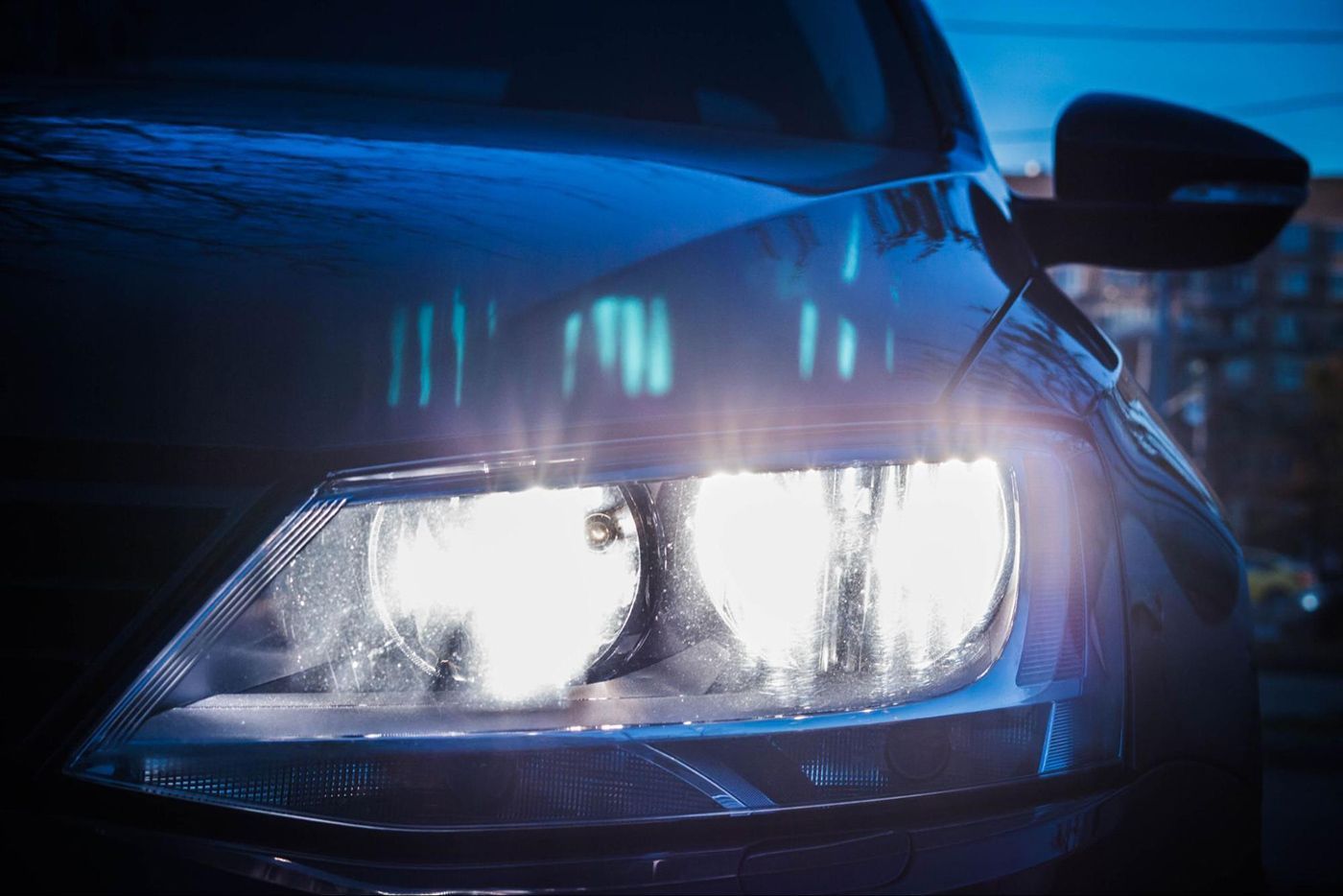 A close up of a car 's headlights at night.