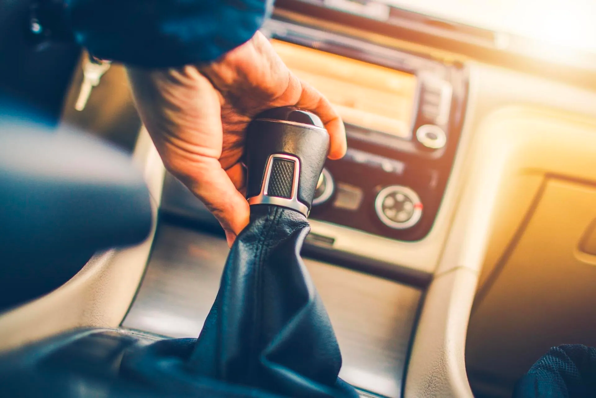 A person is changing the gears in a car.