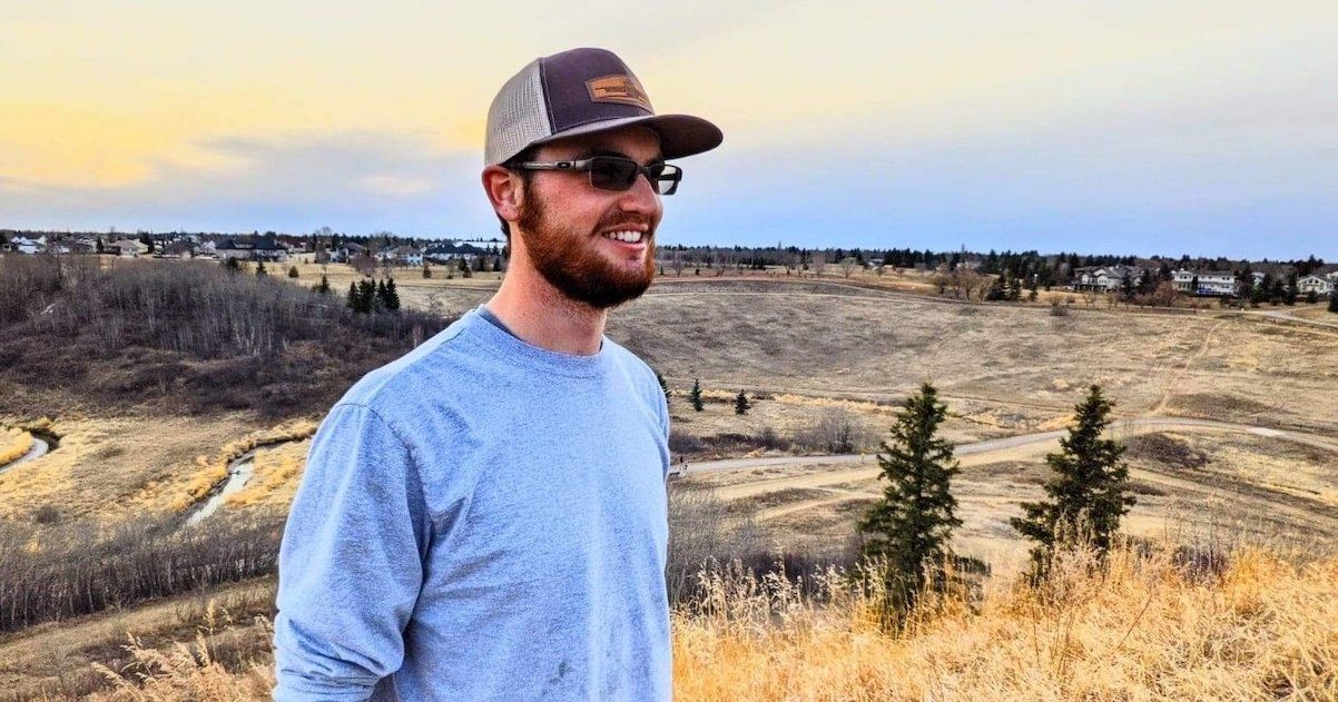 Branden standing on top of a hill enjoying the scenery.