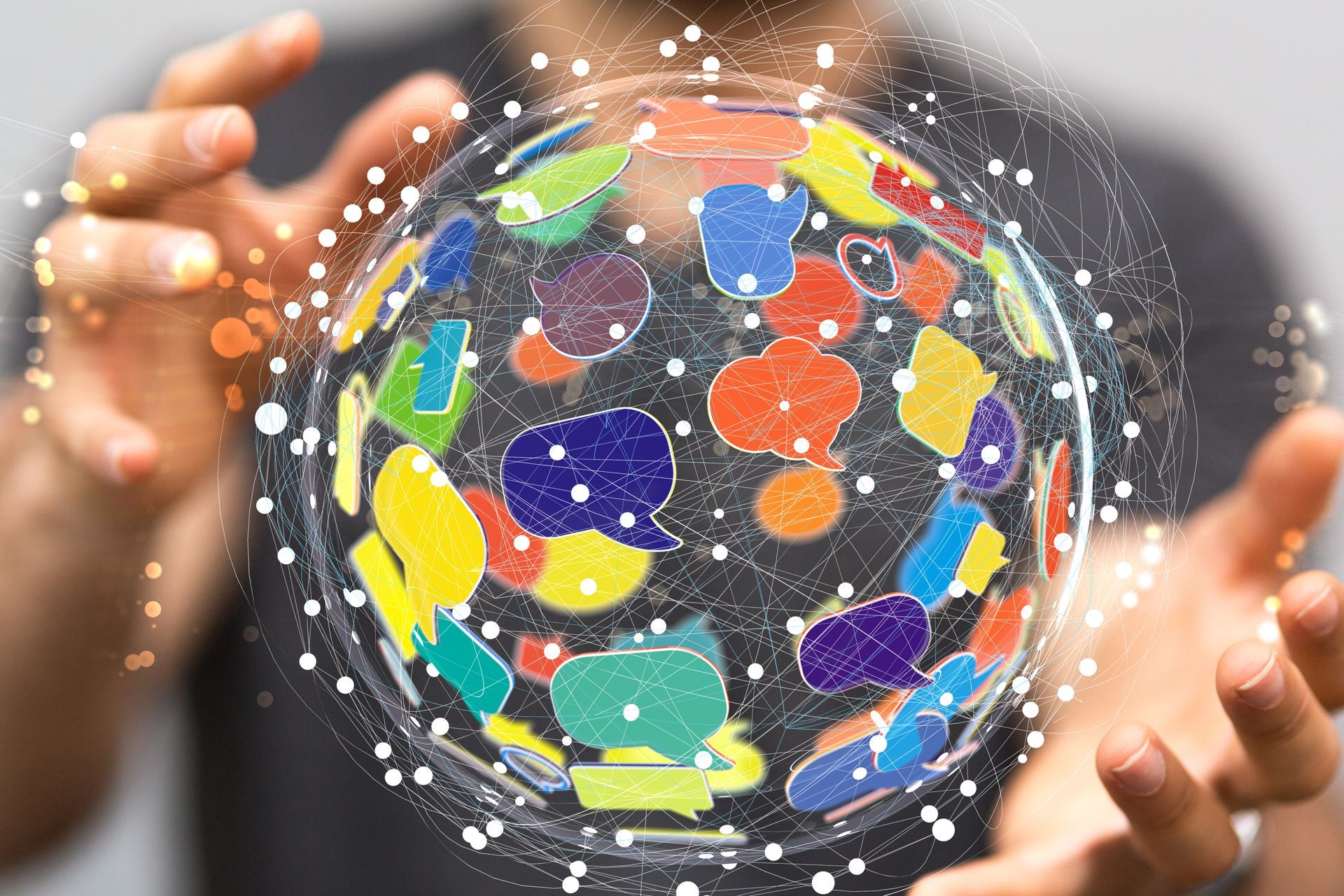 Hands holding a glowing globe with colorful speech bubbles and icons, suggesting global communication
