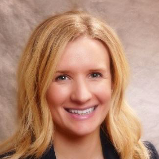 Smiling blonde portrait against a soft gray background