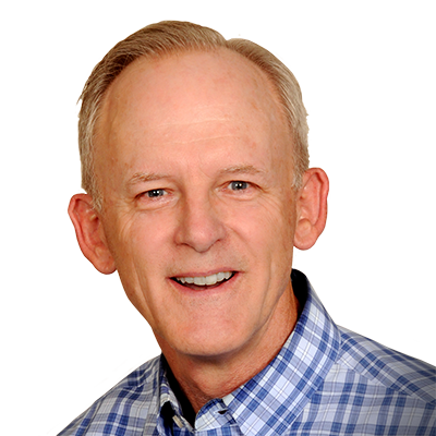 Portrait of a smiling man in a blue plaid shirt against a white background