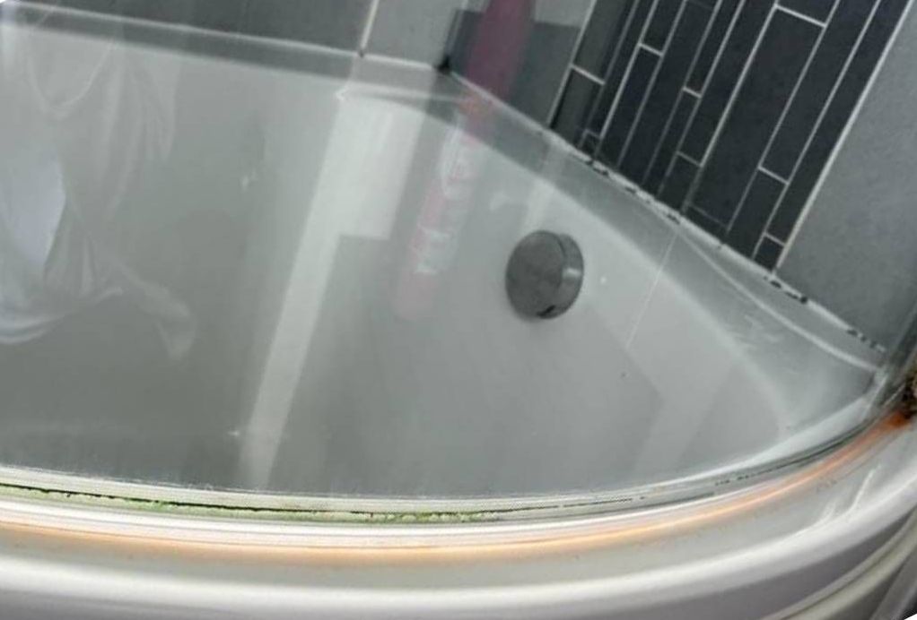 Squeaky Cleaners nottingham before cleaning out the hard scale and mould from the bottom of a shower screen