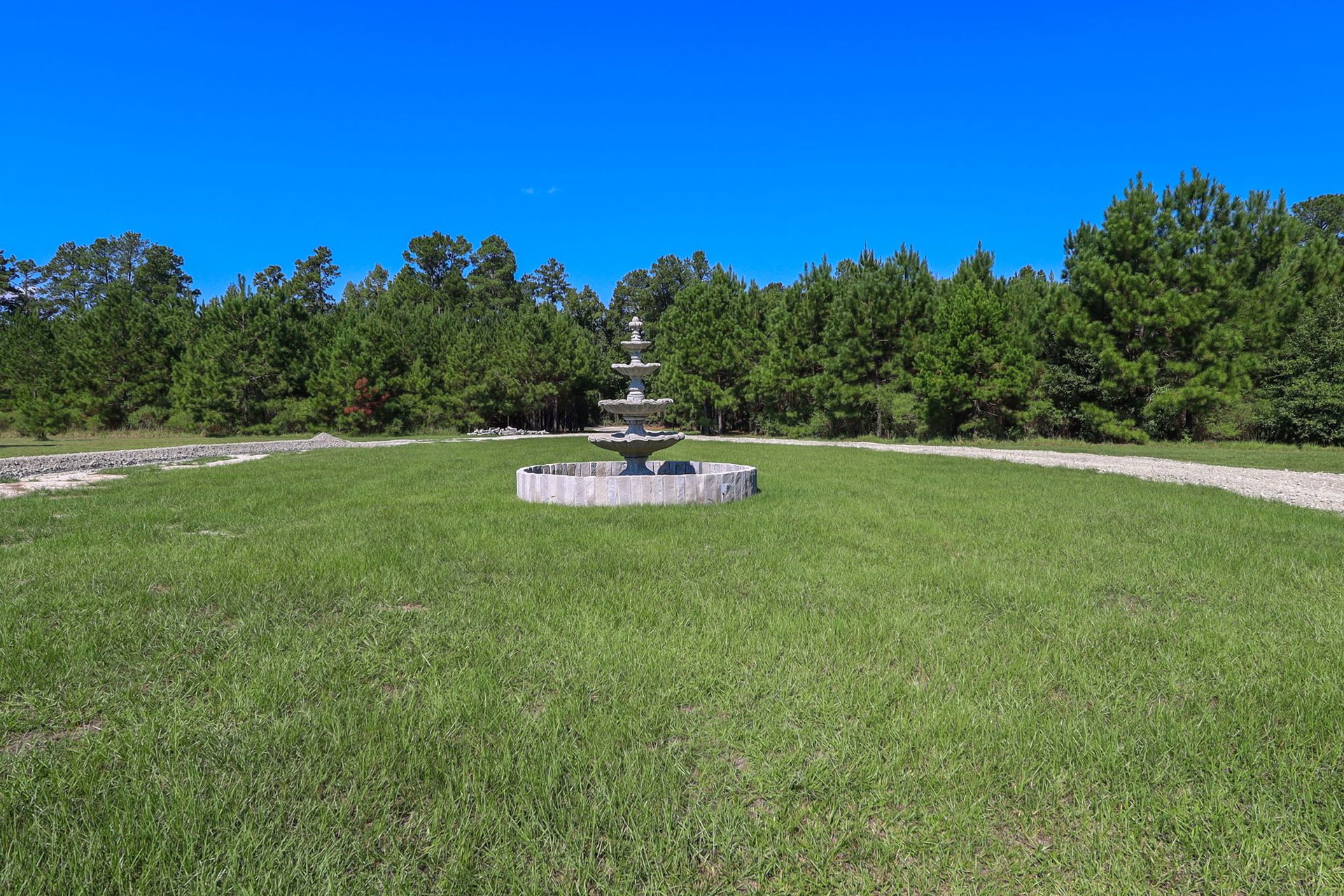Open lawn with a fountain at The Greystone Estate