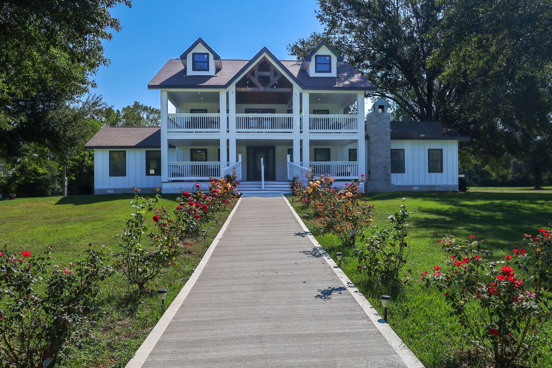 Rose-lined walkway to the front porch of The Greystone Estate