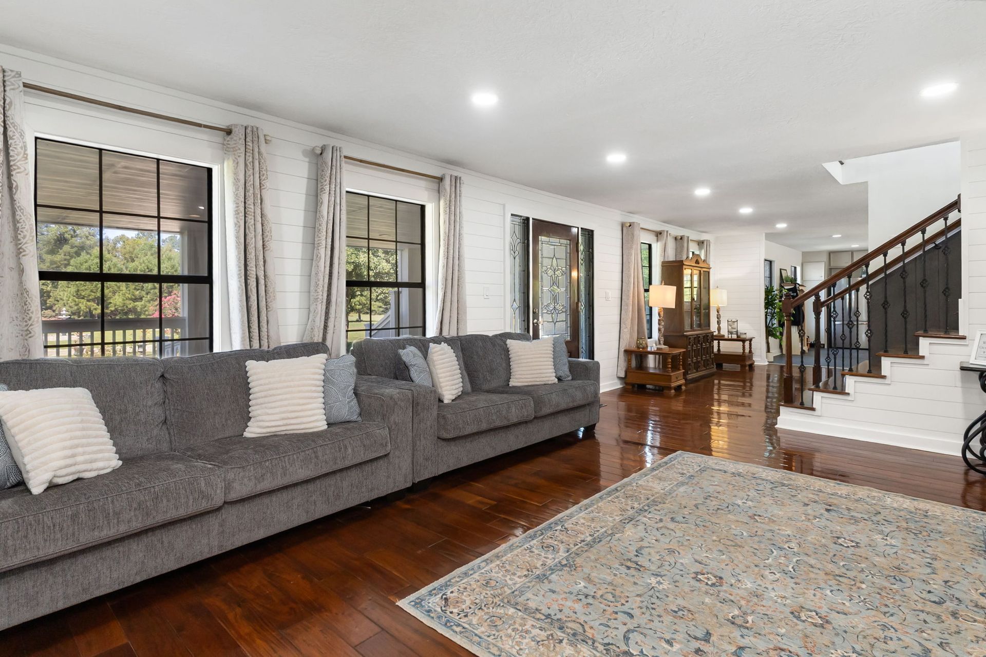 Living room with sectional sofas and hardwood floors