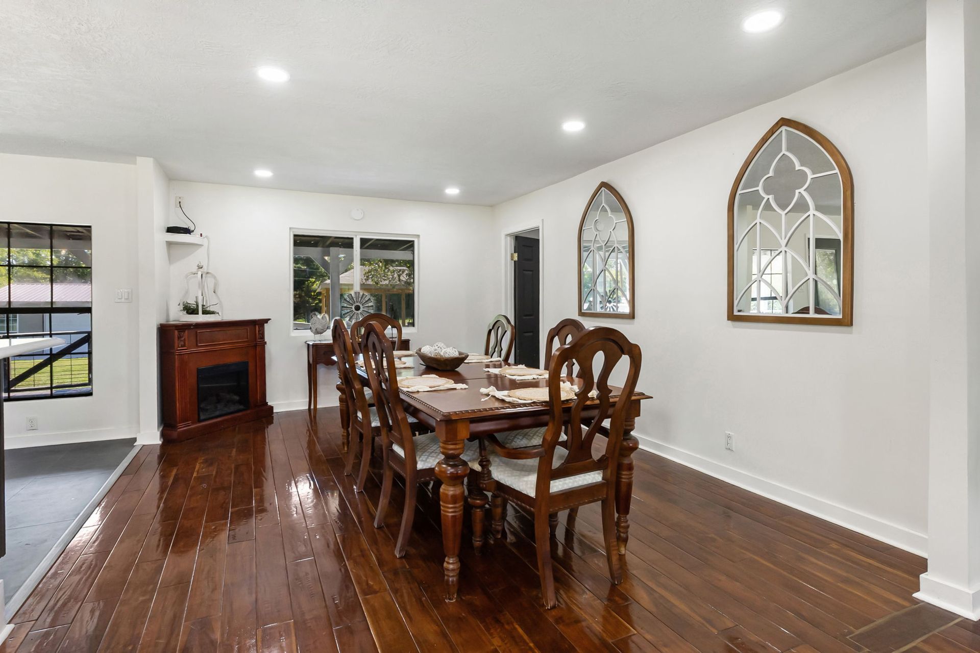 Dining room with farmhouse table and arched mirrors