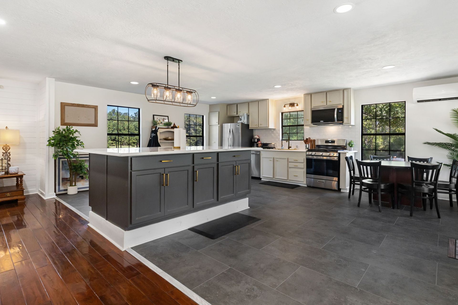 Kitchen island with pendant lighting and stainless appliances