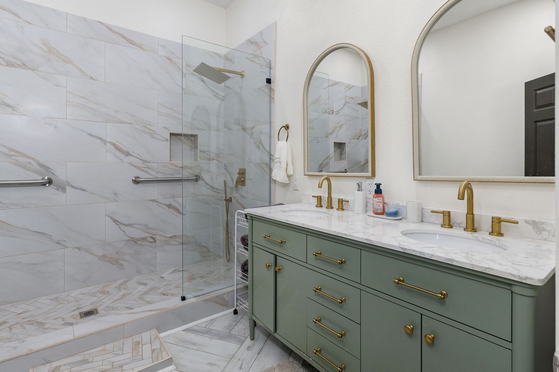 Bathroom with marble walk-in shower and gold fixtures