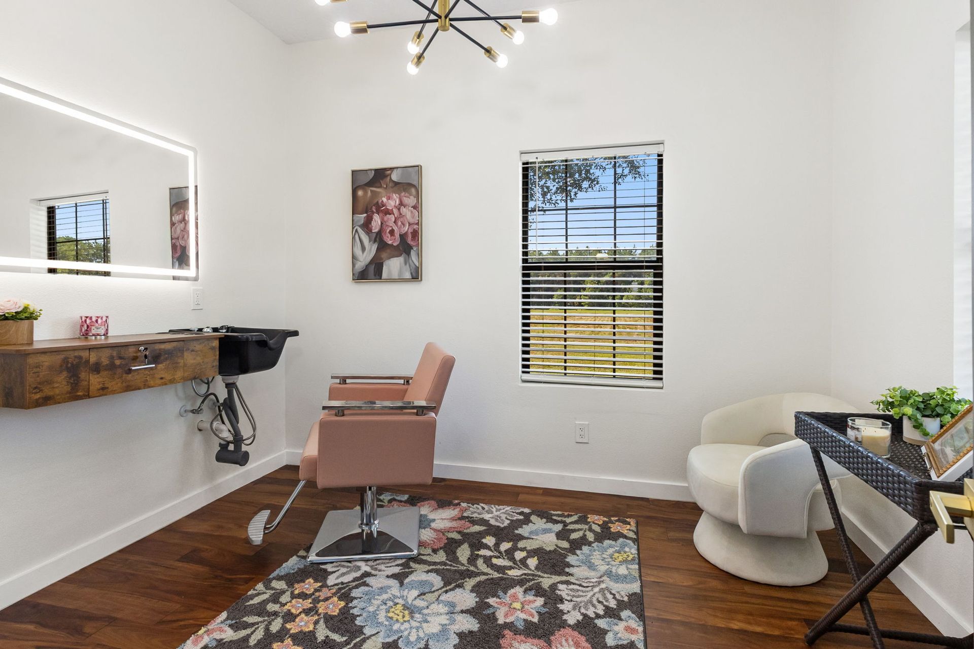 Styling room with salon chair and lighted vanity mirror