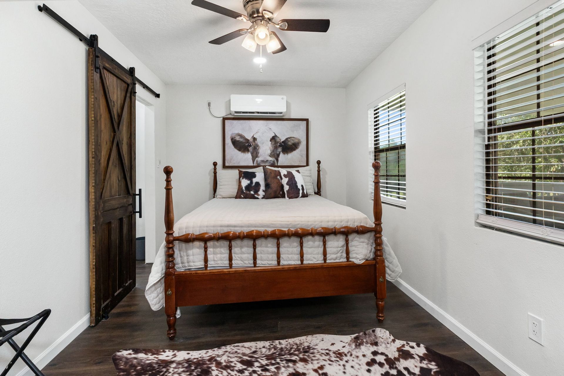 Bedroom with spindle bed and sliding barn door