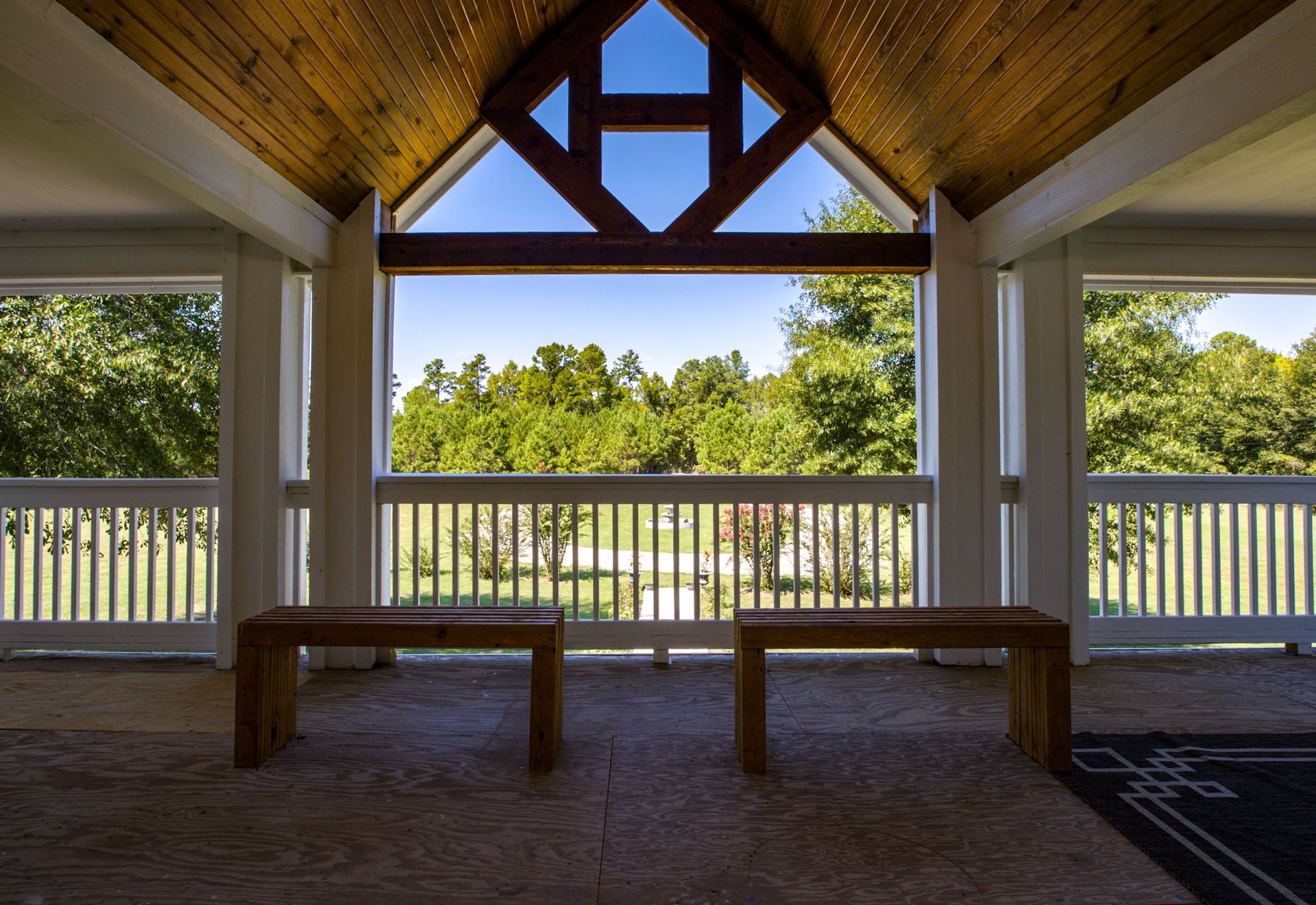 Screened porch with vaulted wood ceiling and countryside views