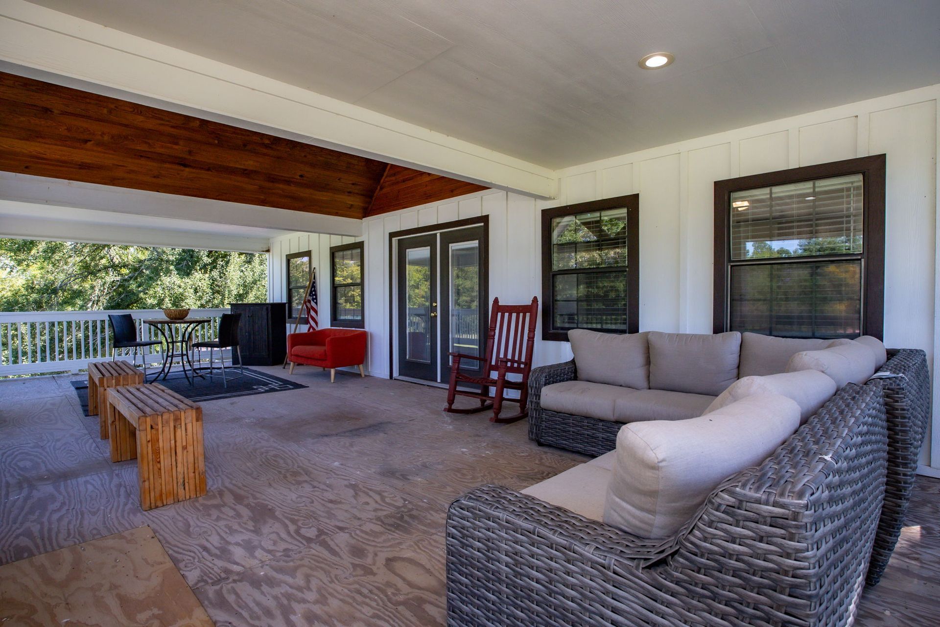 Covered back patio with outdoor sectional and rocking chairs