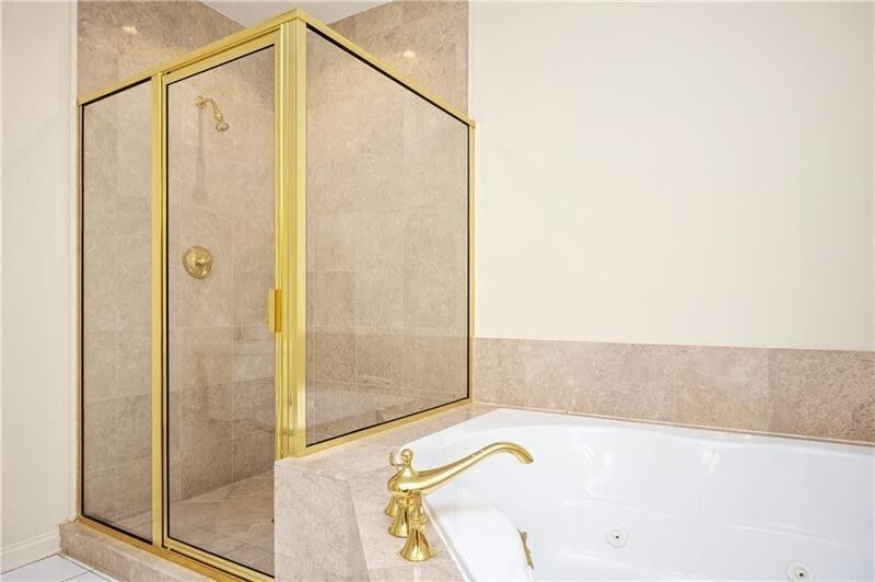 A bathroom with a walk in shower and a bathtub