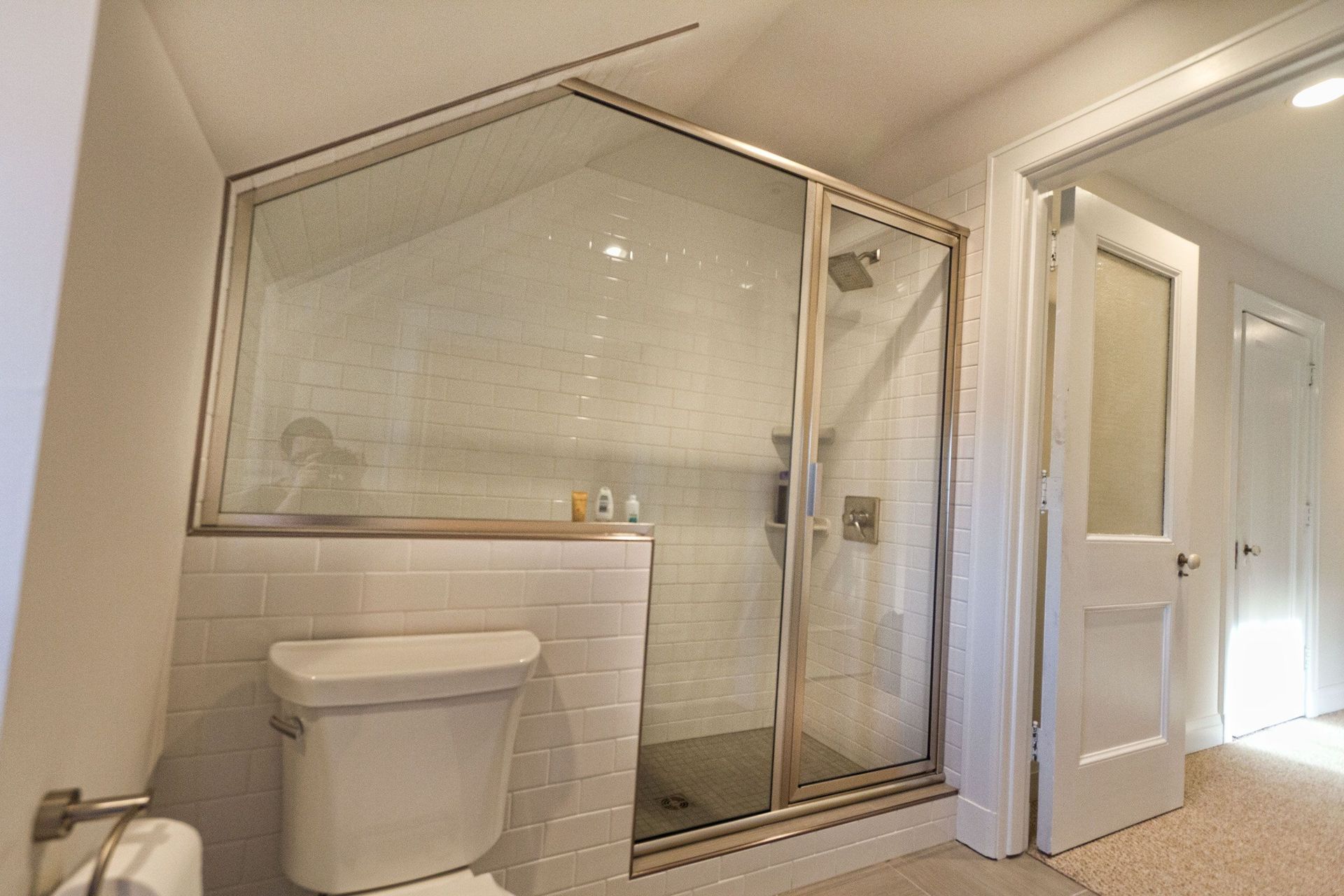 A bathroom with a toilet and a walk in shower