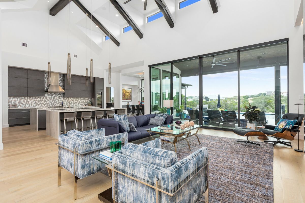 A living room with a lot of furniture and a large window.