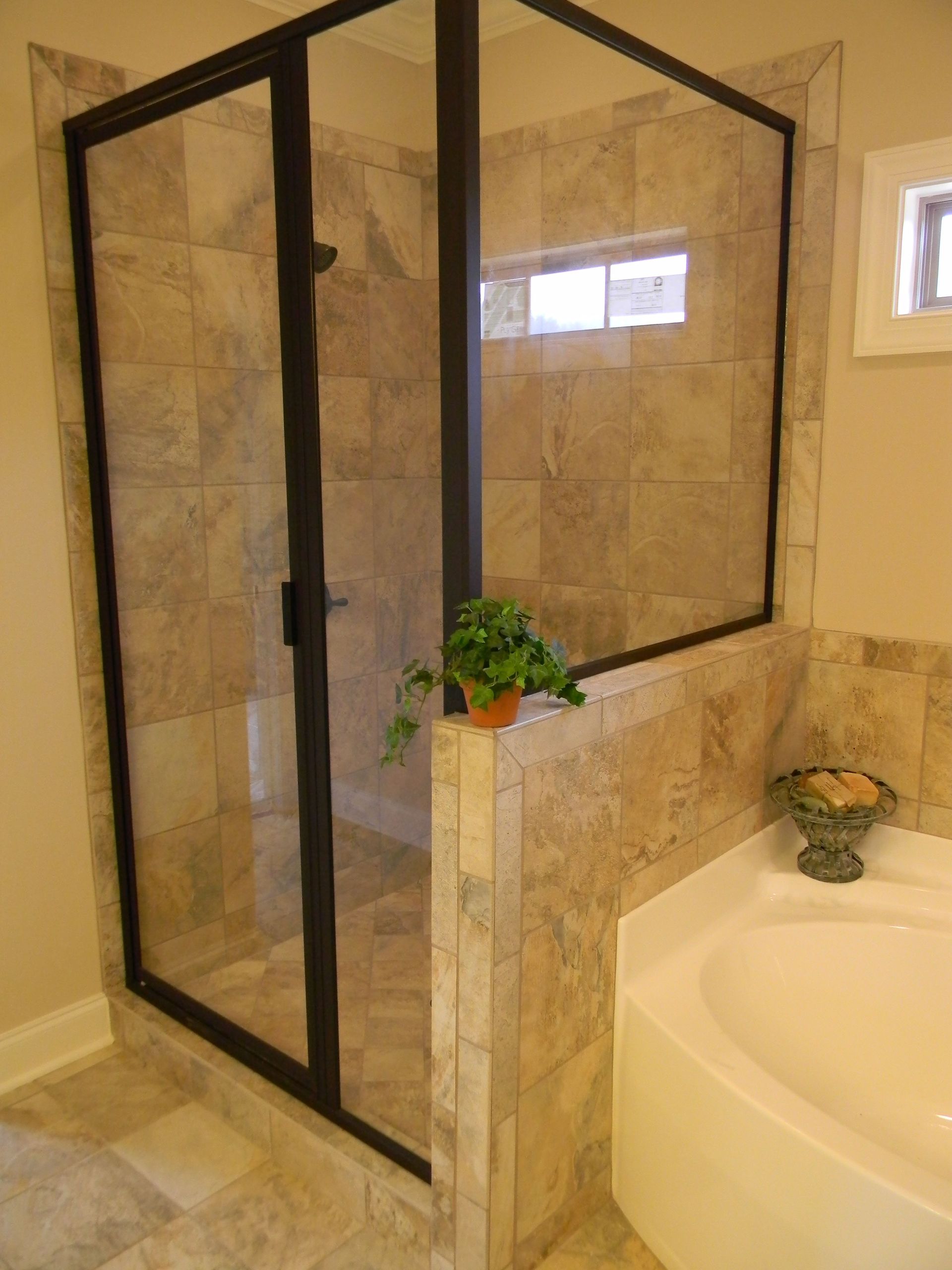 A bathroom with a tub and a walk in shower