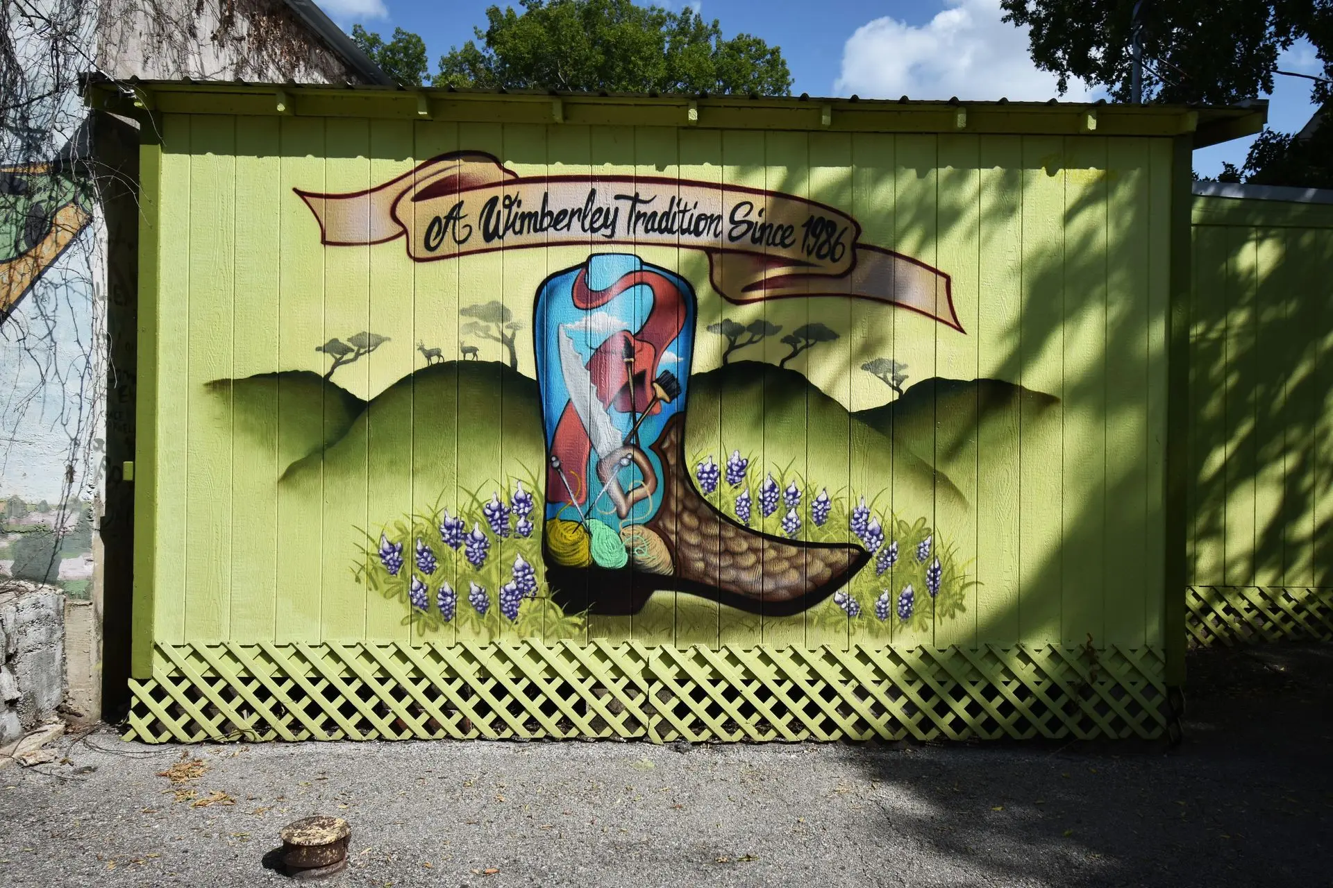 A painting of a cowboy boot on the side of a building
