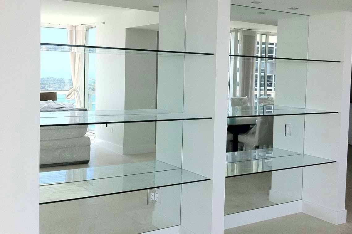 A room with a lot of glass shelves and mirrors