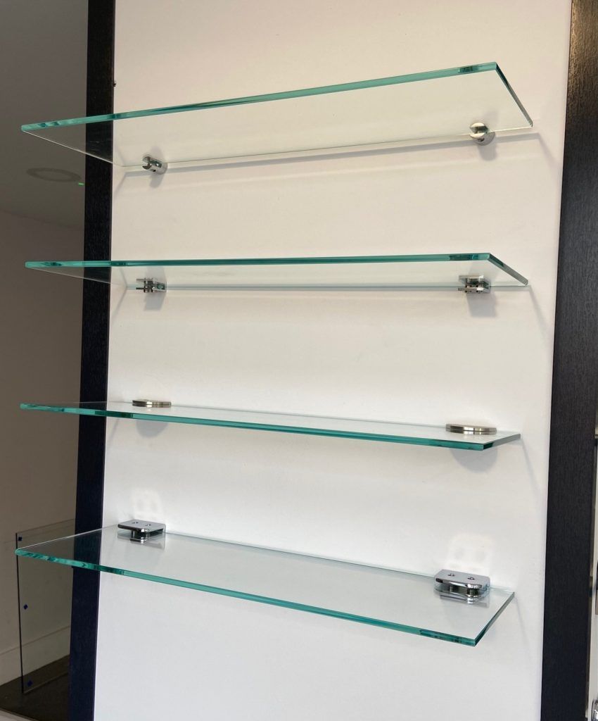 showing a row of glass shelves installed/mounted on the wall