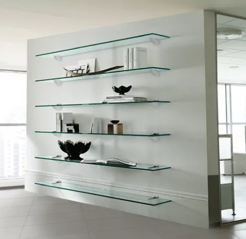 A white wall with glass shelves on it