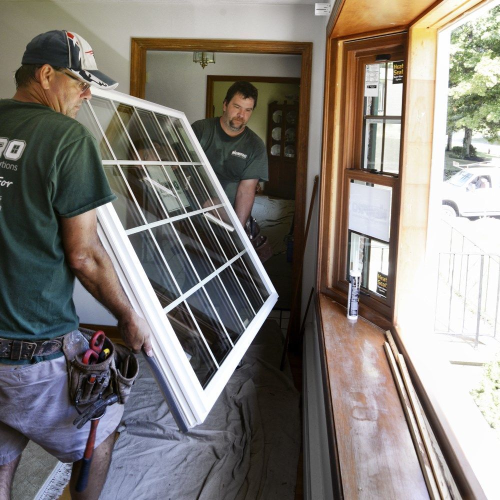 RGC glaziers installing new window frame into window opening.