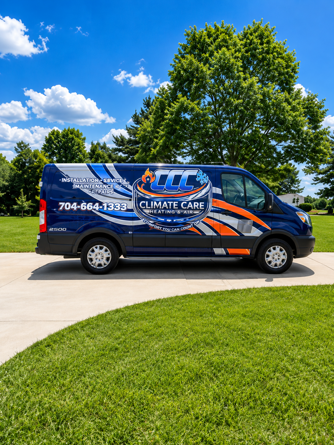 Blue Climate Care service van parked on a sunny street beside green lawn and trees.