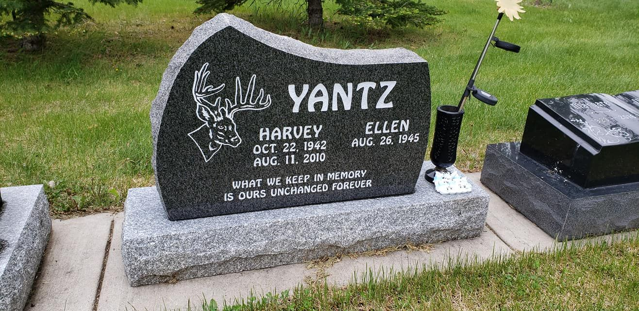 Headstone engraved with the name Yantz, dates of birth and death, and a deer silhouette.
