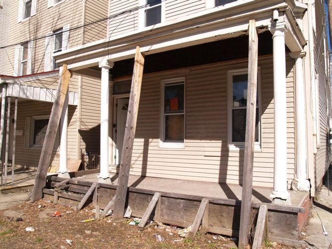 A house with a porch that is being demolished