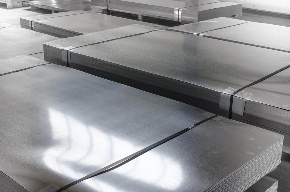 A Bunch of Metal Sheets Are Stacked on Top of Each Other in A Room — K & S Sheetmetal in Gladstone Central, QLD