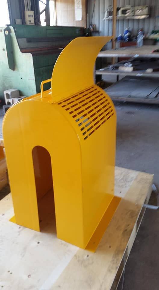 A Yellow Object Is Sitting on Top of A Wooden Table — K & S Sheetmetal in Gladstone Central, QLD